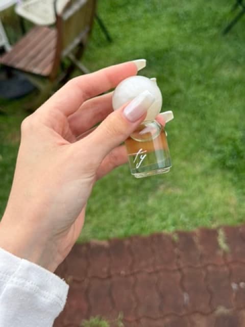 Perfume bottle held in hand