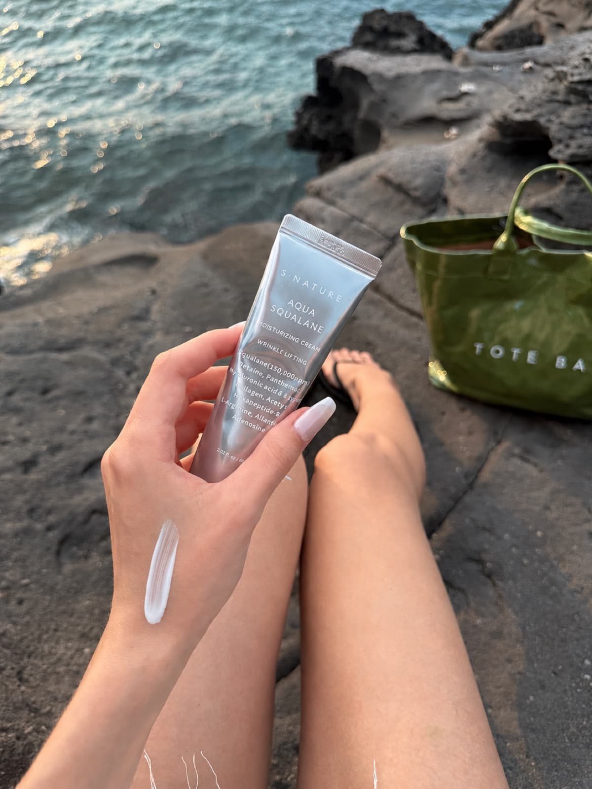 Cream tube held by the sea