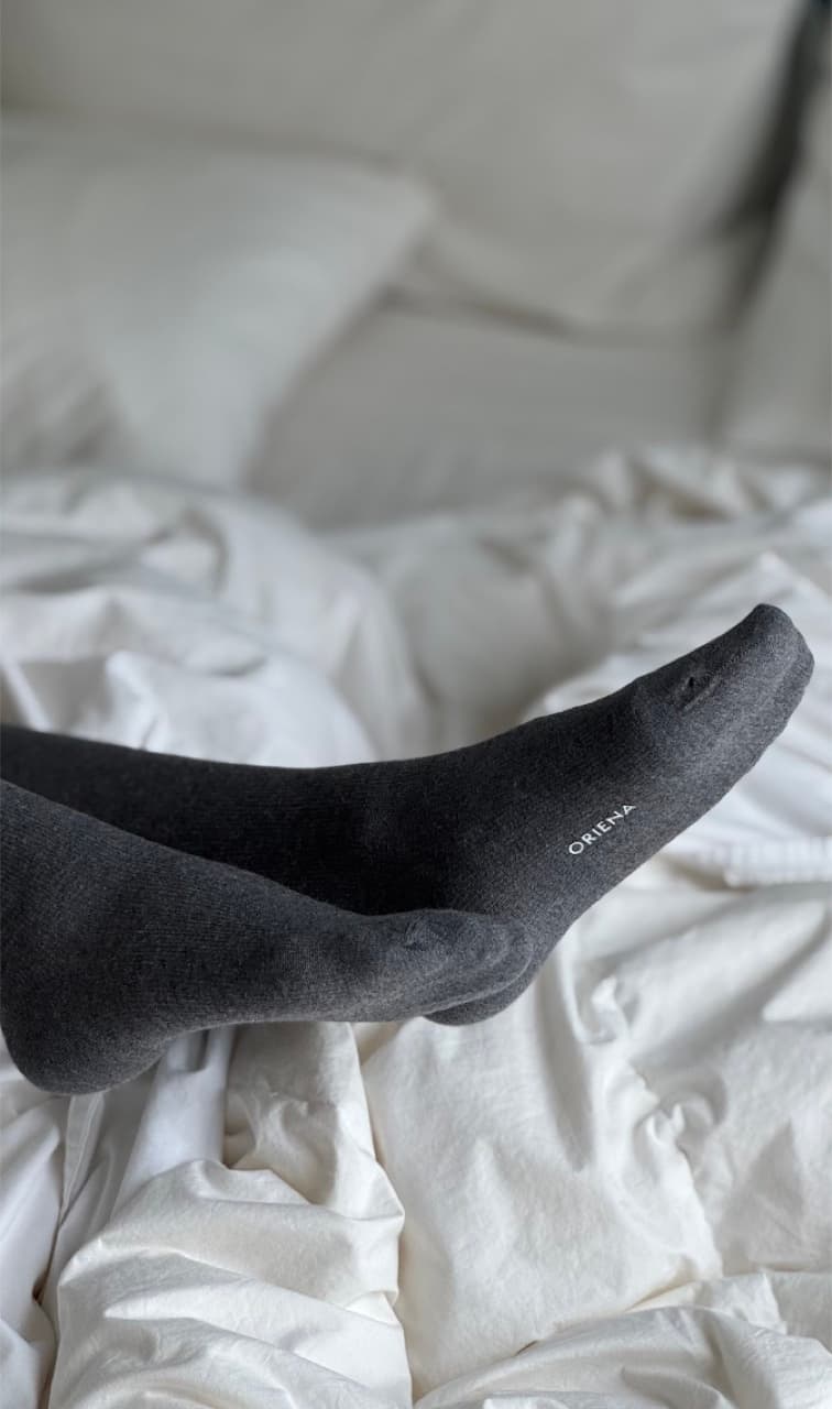 Compression socks worn on a bed
