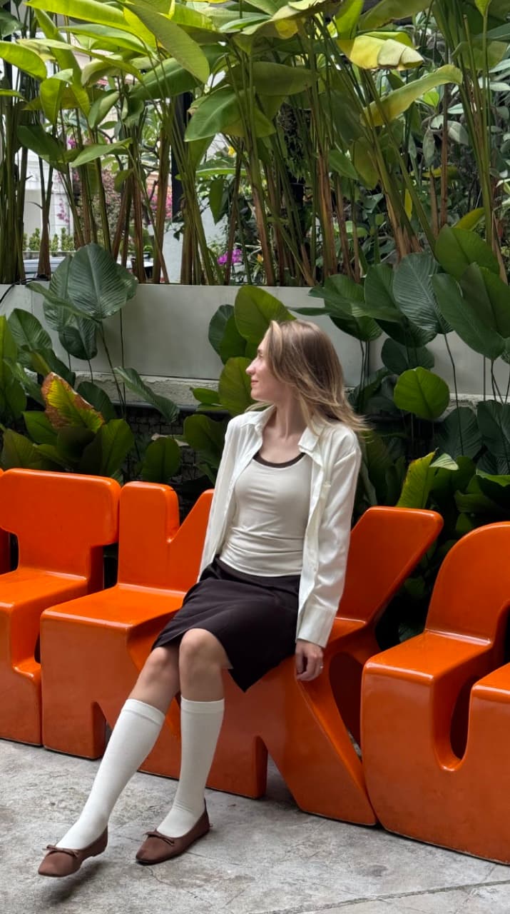 Sitting on orange chairs among plants