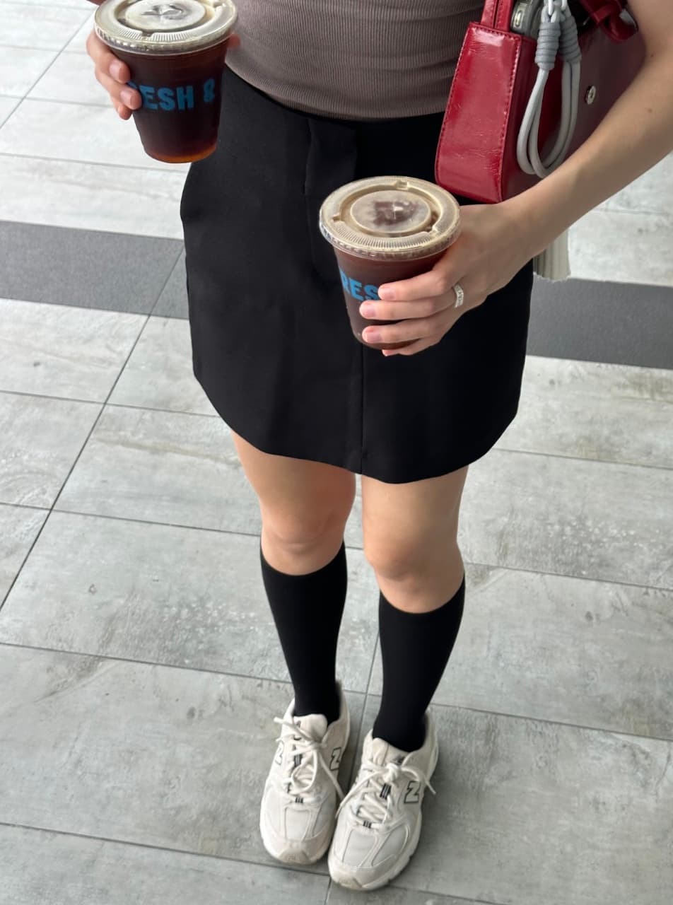 Holding two iced coffees